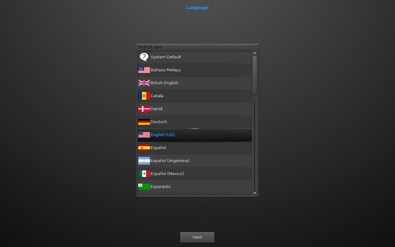 Layar wizard konfigurasi Moksha berjudul Language dengan daftar pilihan bahasa (System Default, Bahasa Melayu, British English, Catala, Dansk, Deutsch, English US terpilih, Espanol, dan lainnya) serta tombol Next