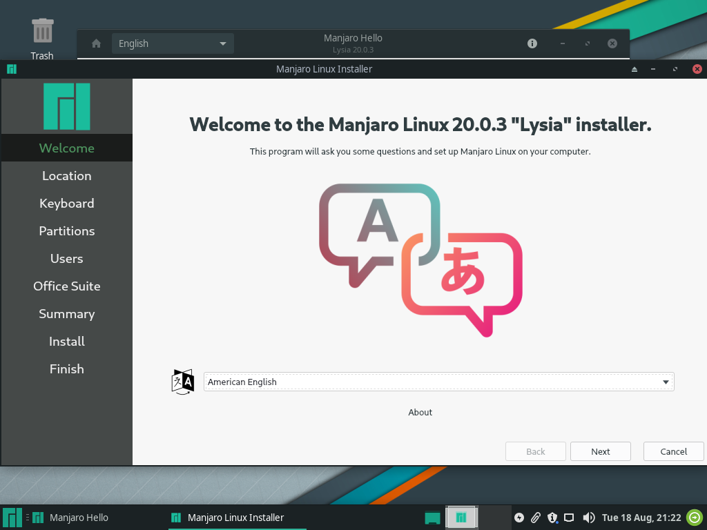 Layar pembuka installer Manjaro Linux dengan dropdown pilihan bahasa American English dan tombol Next