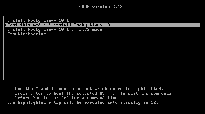 Menu boot GRUB version 2.12 Rocky Linux 10.1 dengan empat pilihan: Install Rocky Linux 10.1, Test this media and install Rocky Linux 10.1 tersorot, Install Rocky Linux 10.1 in FIPS mode, dan Troubleshooting, hitung mundur otomatis 52 detik