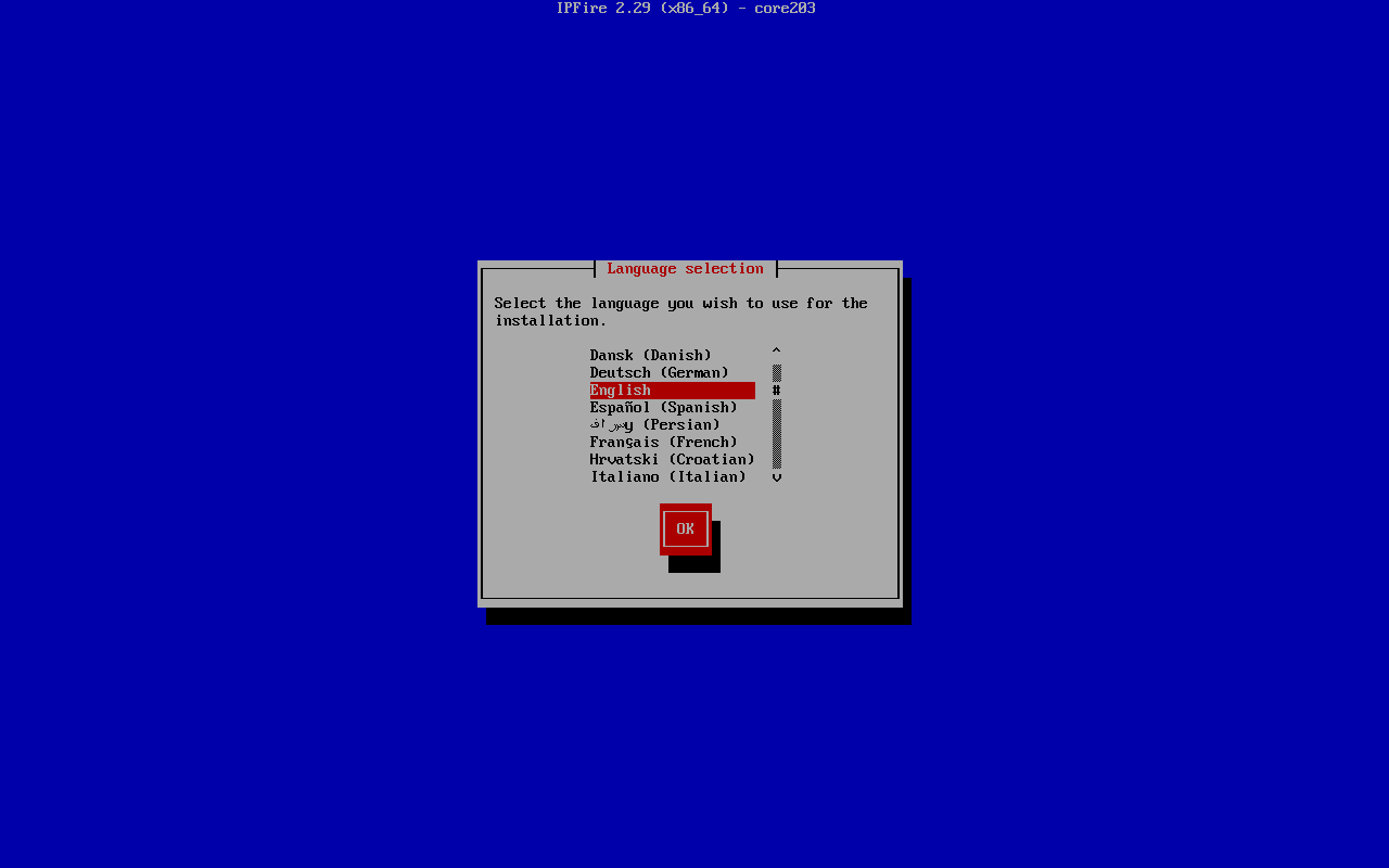 Dialog Language selection instalasi IPFire 2.29 core203 bergaya teks biru dengan daftar pilihan bahasa Dansk, Deutsch, English (terpilih), Espanol, Persian, Francais, Hrvatski, Italiano dan tombol OK