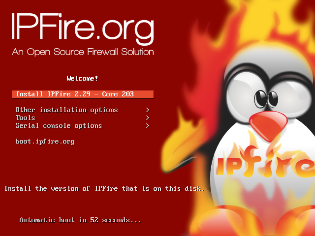 Menu boot DVD installer IPFire 2.29 Core 203 dengan logo penguin dan api bertuliskan IPFire.org, pilihan Install IPFire 2.29 - Core 203, Other installation options, Tools, Serial console options, dan hitung mundur boot otomatis 52 detik