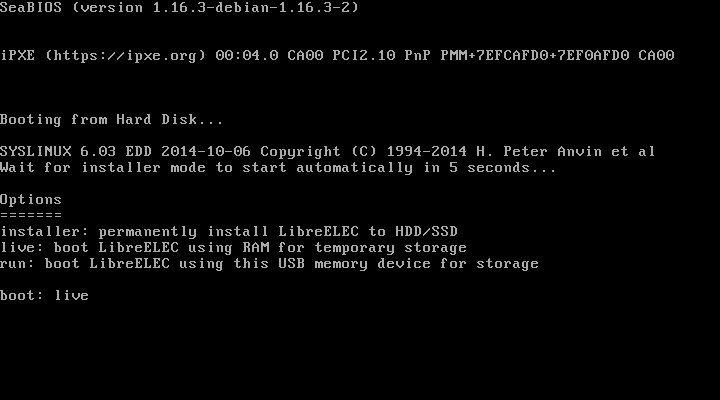 Layar boot SeaBIOS dan menu syslinux LibreELEC 12.2.1 dengan tiga opsi installer, live, dan run, dengan kata live sudah diketik di baris boot