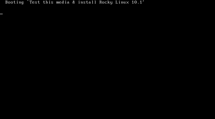 Layar hitam dengan tulisan Booting Test this media and install Rocky Linux 10.1 di pojok kiri atas saat kernel installer mulai dimuat dari DVD