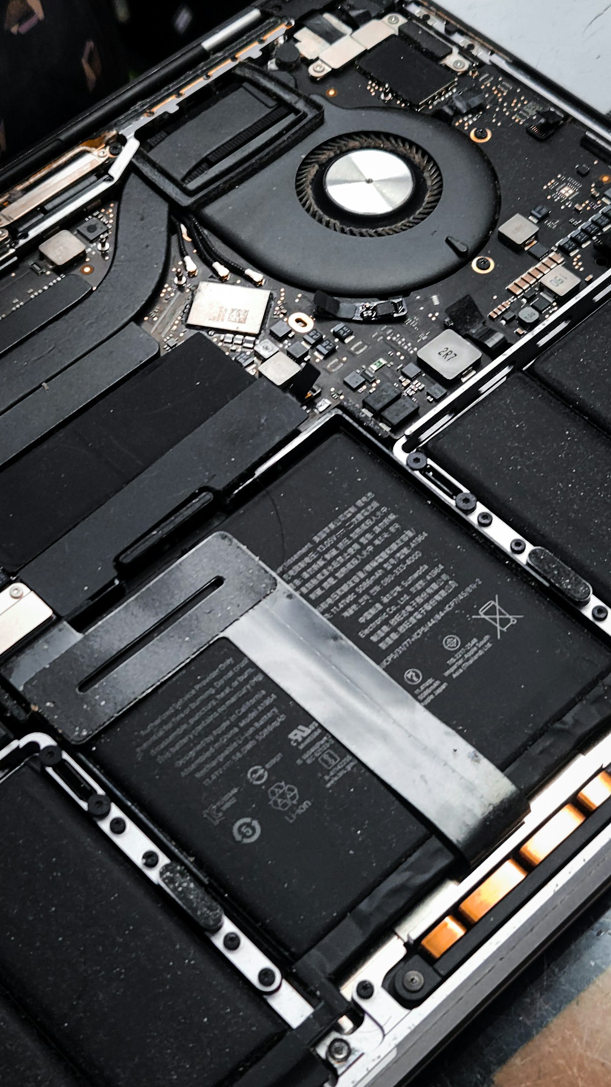 Interior laptop dibuka menampilkan baterai dan kipas