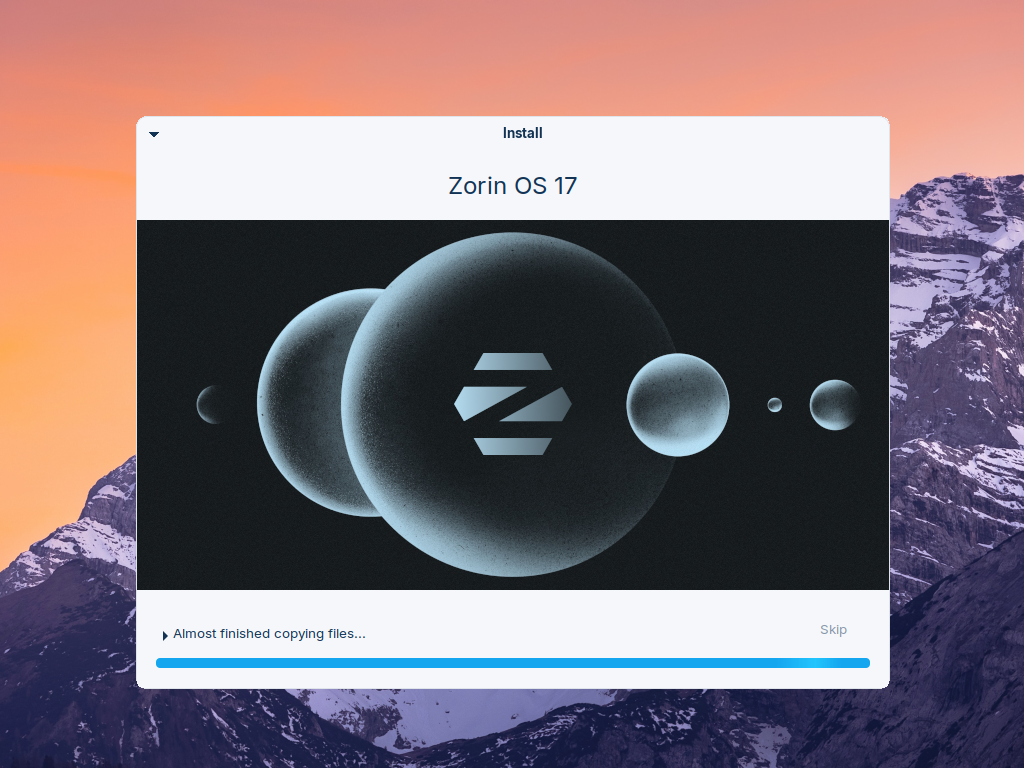 Layar instalasi Zorin OS menampilkan slide perkenalan dengan bilah kemajuan hampir penuh dan keterangan Almost finished copying files